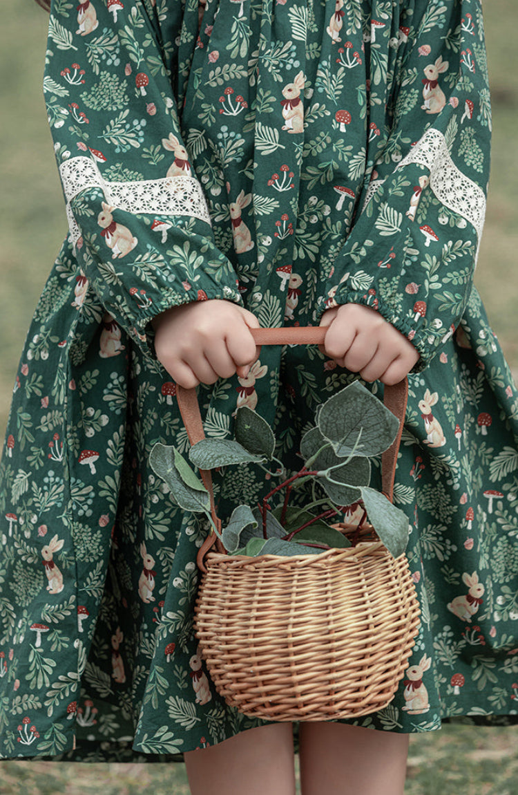 Close-up of lace details on girls green floral dress