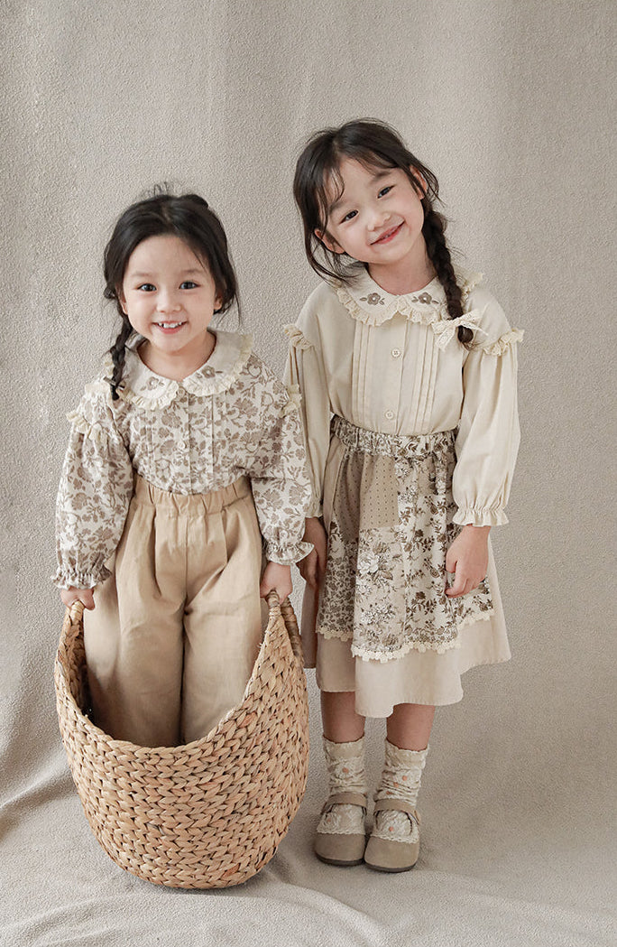 Girls wearing blouse with lace-trimmed collar with flower embroidery