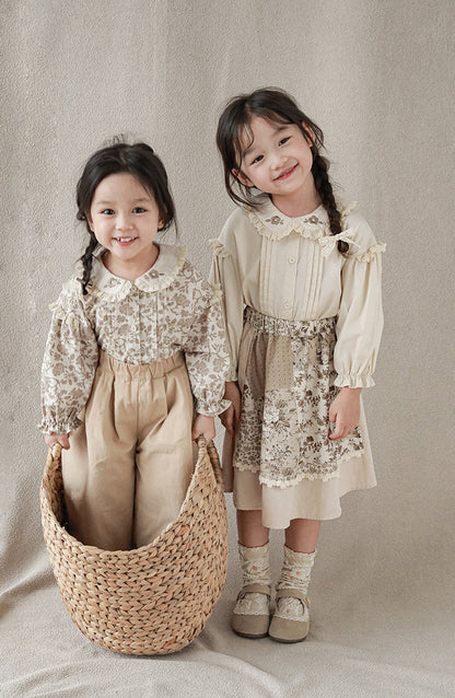 Girls wearing blouse with lace-trimmed collar with flower embroidery