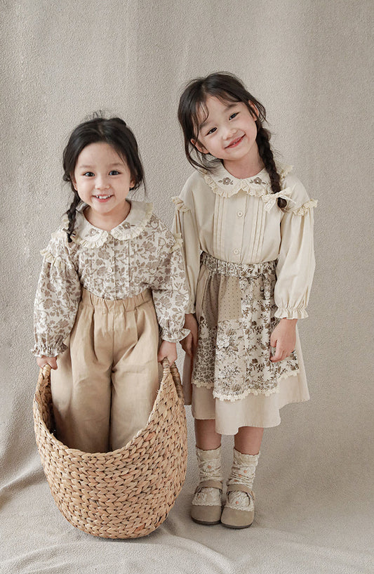 Girls wearing blouse with lace-trimmed collar with flower embroidery