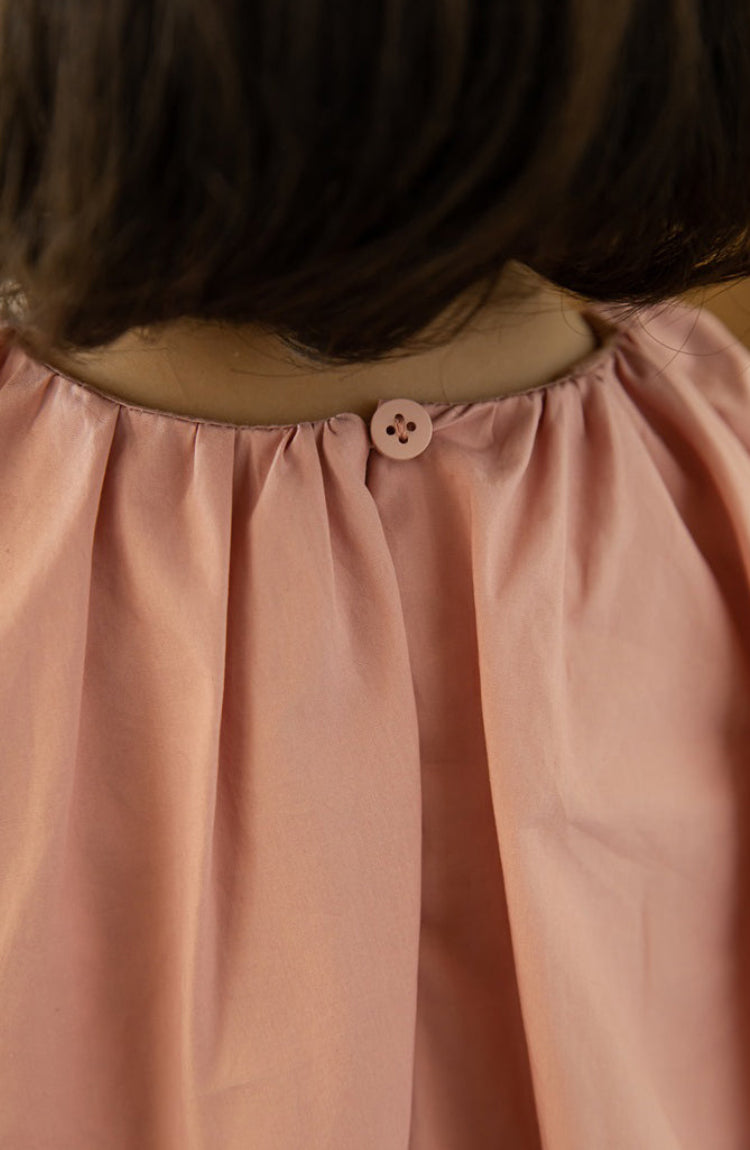 Back view showing single button closure on summer dress