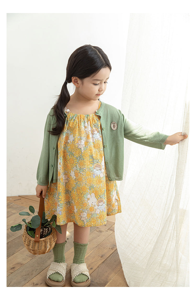 Girl wearing breathable summer lyocell cardigan with bear patch, in sage green.